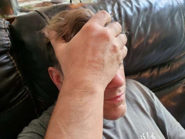 Person holding his head
