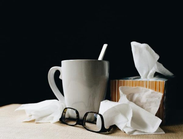 A mug, box of tissues, and glasses
